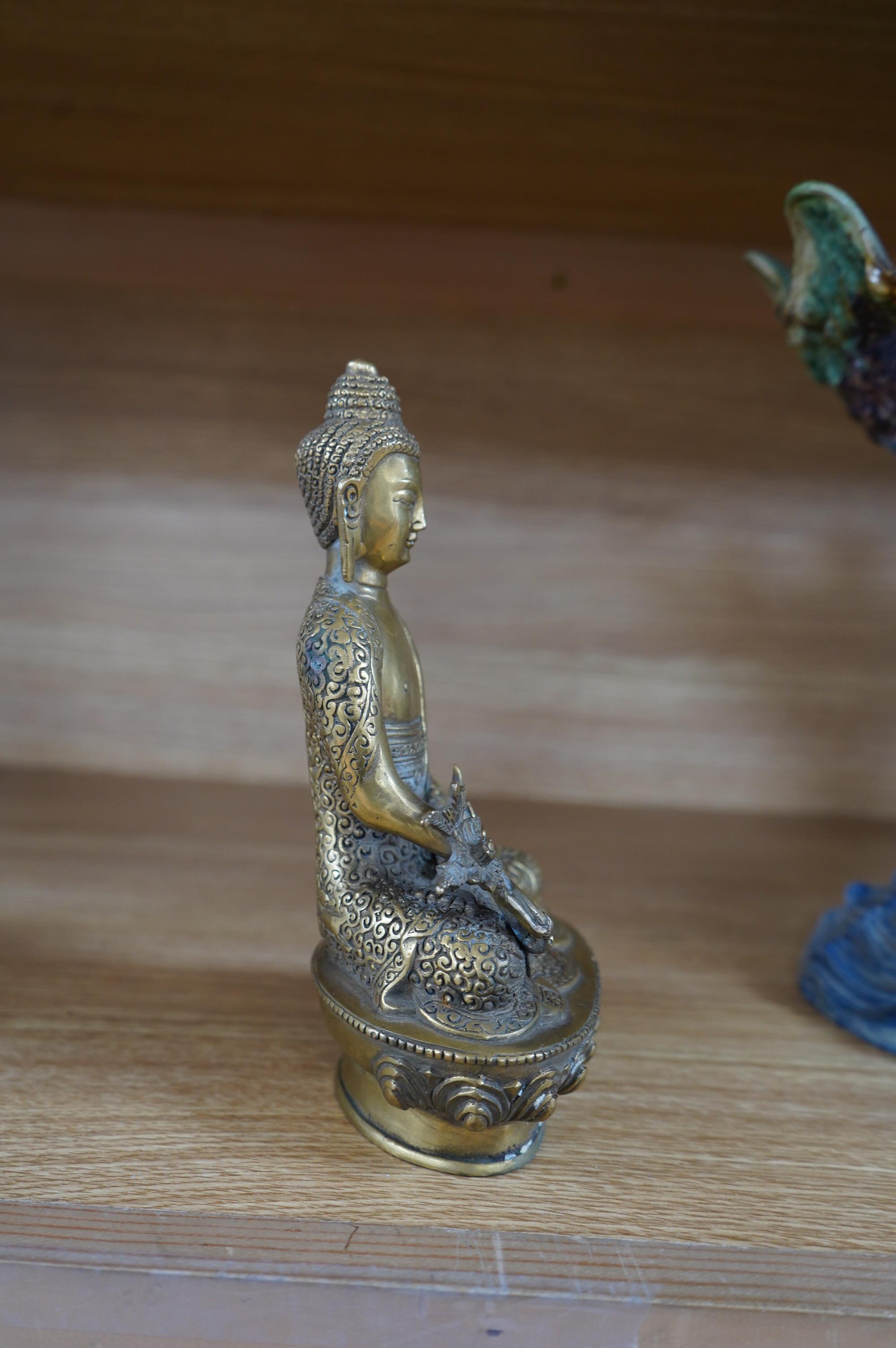 A Tibetan bronze model of a seated Buddha, 19cm. Condition - fair to good